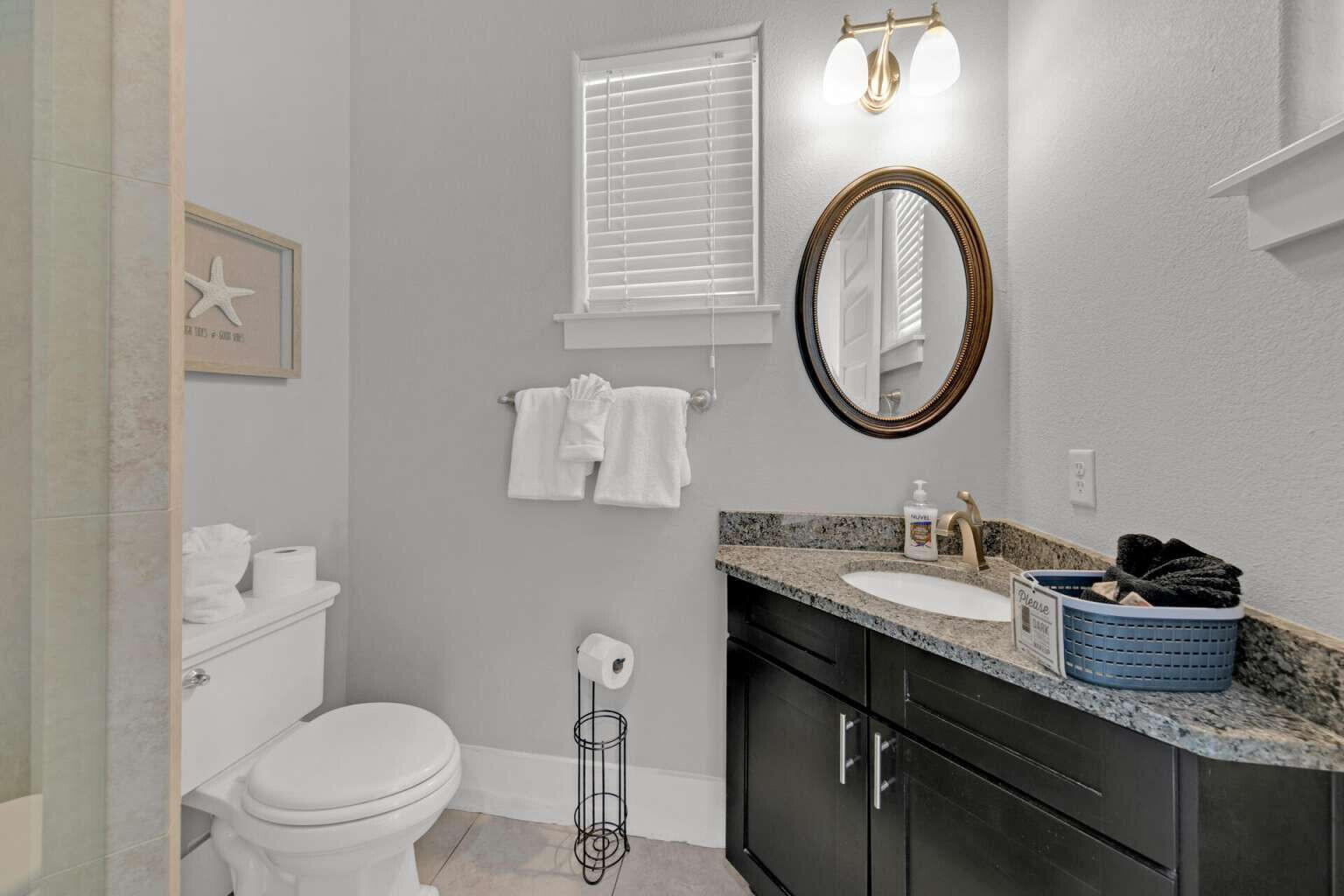 228 Miami Street Miramar Beach, FL 32550 - Photo 12 of 20 a bathroom with a toilet a sink and a mirror