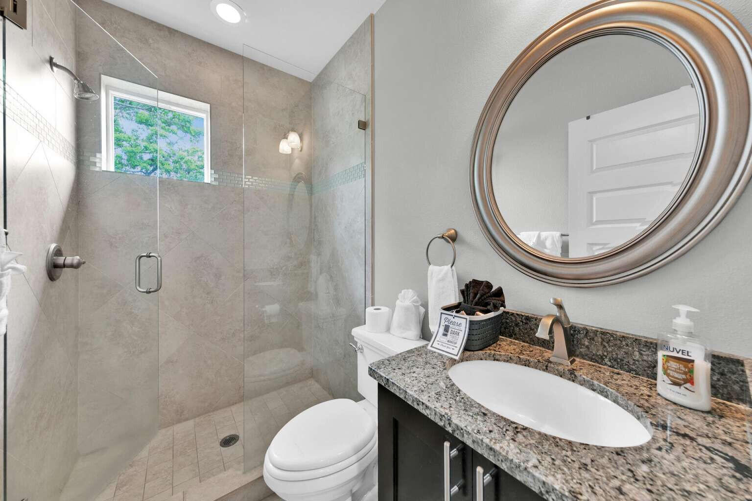 228 Miami Street Miramar Beach, FL 32550 - Photo 16 of 20 a bathroom with a granite countertop toilet a sink and a mirror
