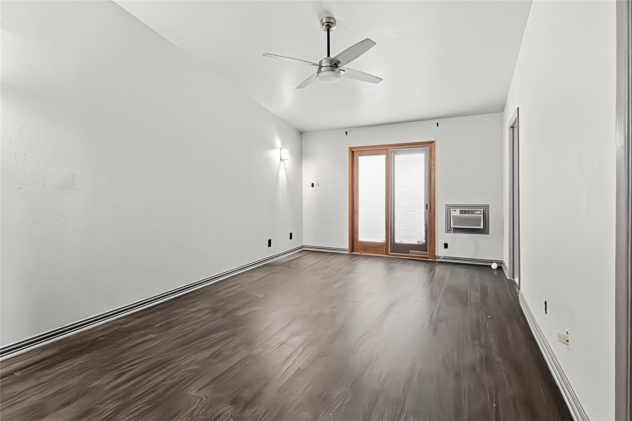 5910 Zenith Street Beaumont, TX 77706 - Photo 23 of 36 an empty room with wooden floor and windows