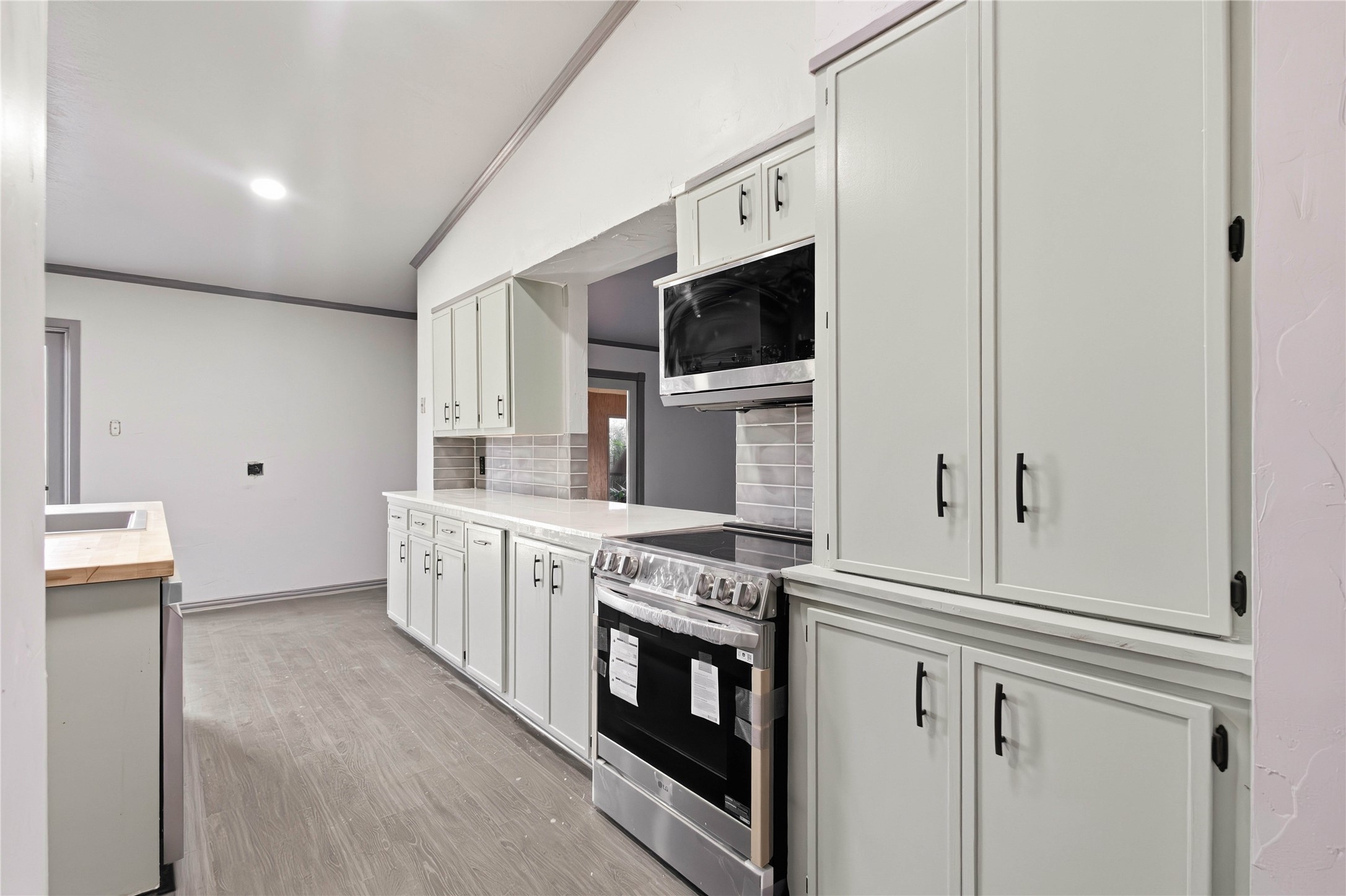 5910 Zenith Street Beaumont, TX 77706 - Photo 28 of 36 a kitchen with stainless steel appliances white cabinets and a refrigerator