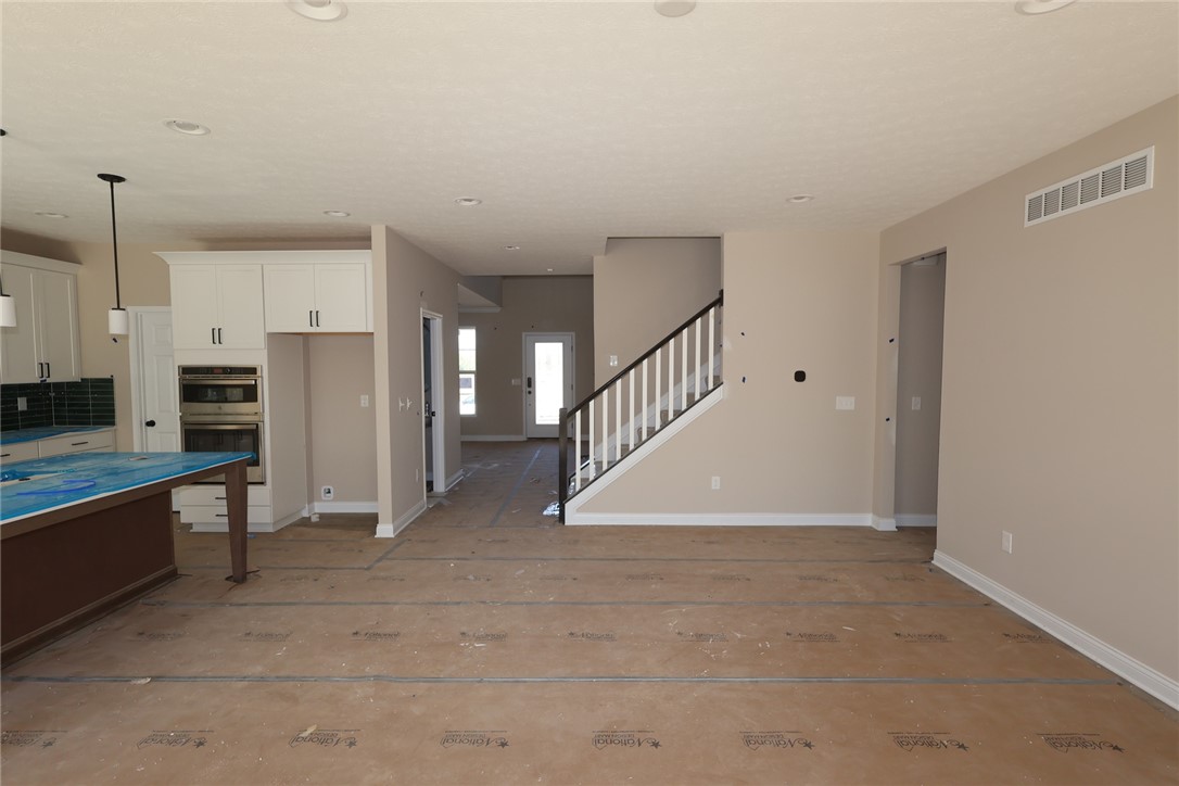 240 Tilly Court, Unit 5 Springboro, OH 45066 - Photo 23 of 26 This expansive open-concept interior seamlessly blends kitchen, dining, and living spaces for modern living.