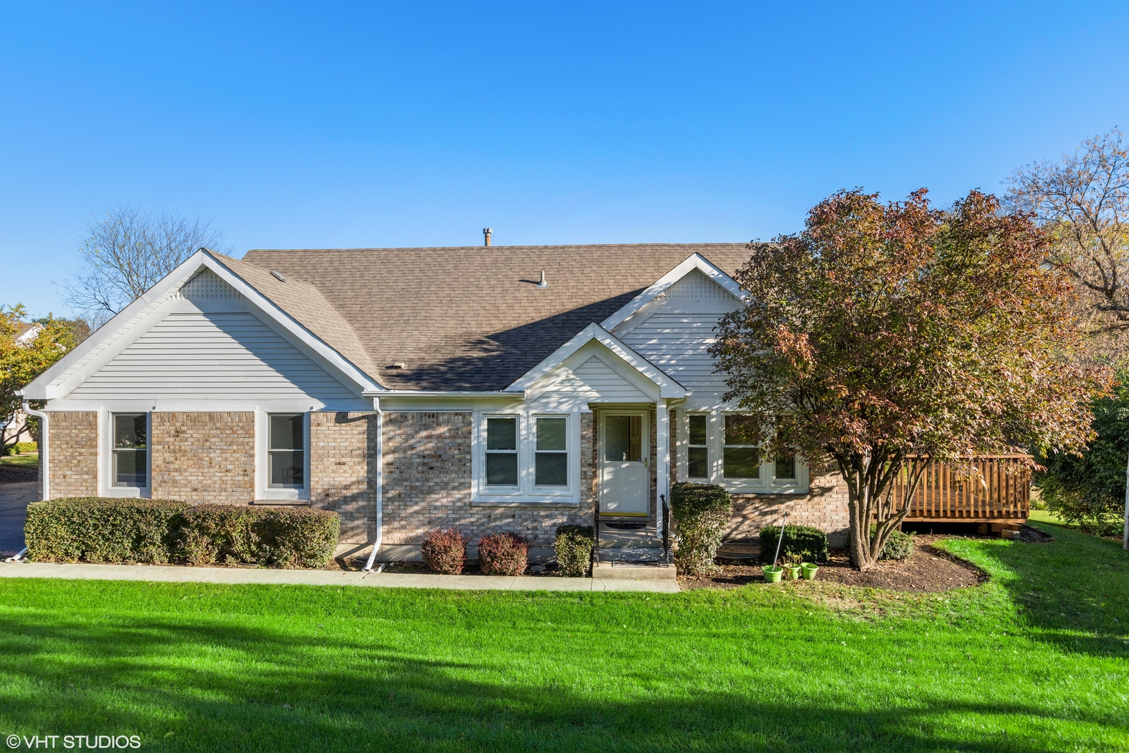 a front view of a house with a yard table and chairs