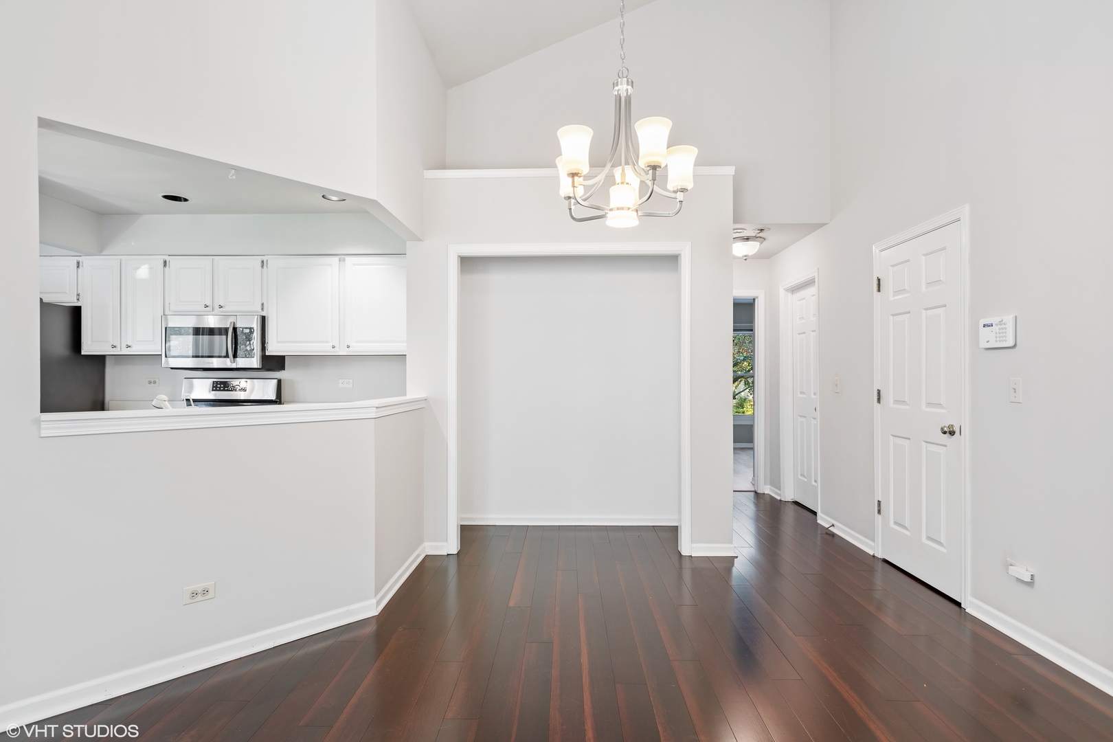 256 Haber Court, Unit 256 Cary, IL 60013 - Photo 3 of 12 a room with stainless steel appliances wooden floor and chandelier