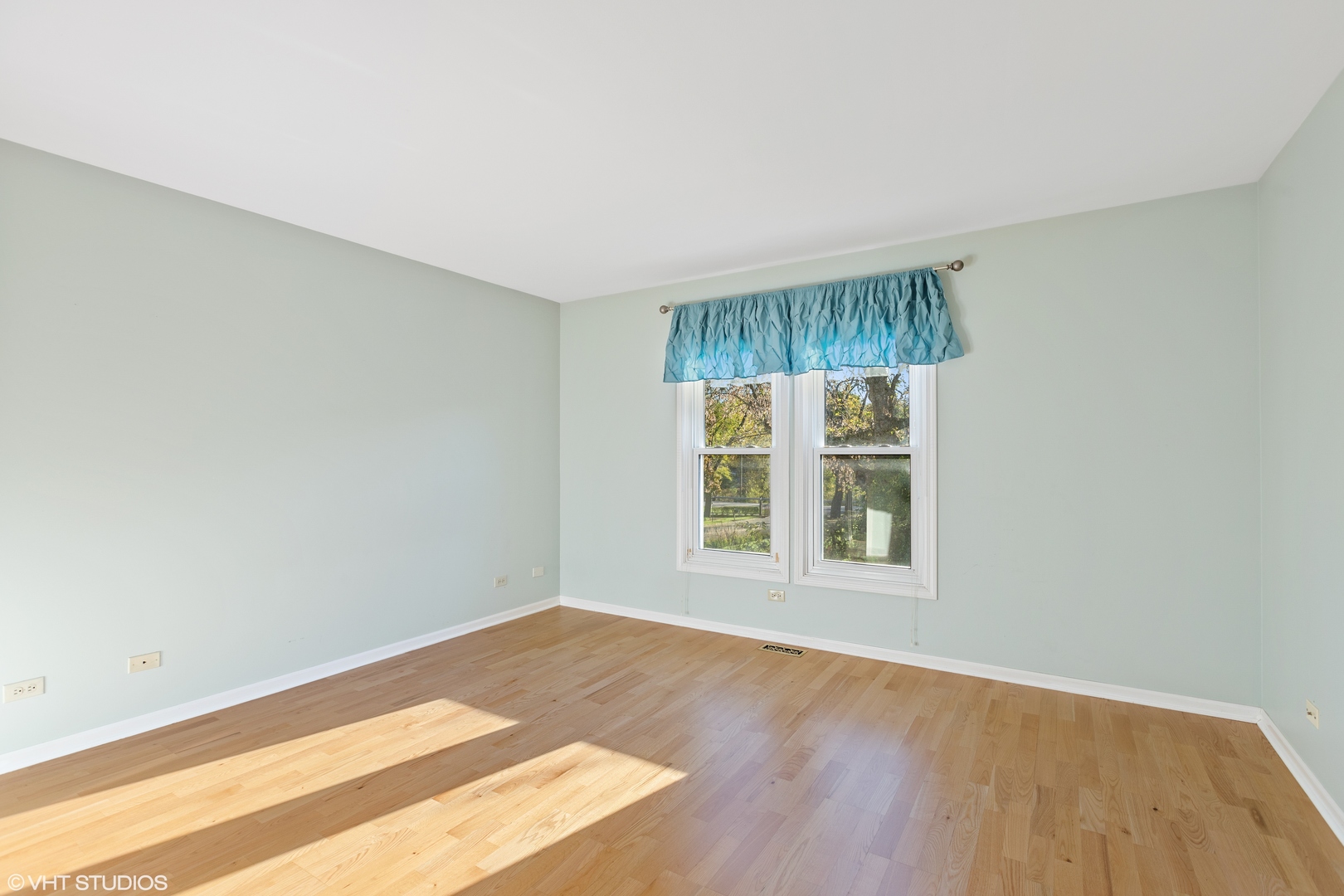 256 Haber Court, Unit 256 Cary, IL 60013 - Photo 6 of 12 an empty room with wooden floor and window