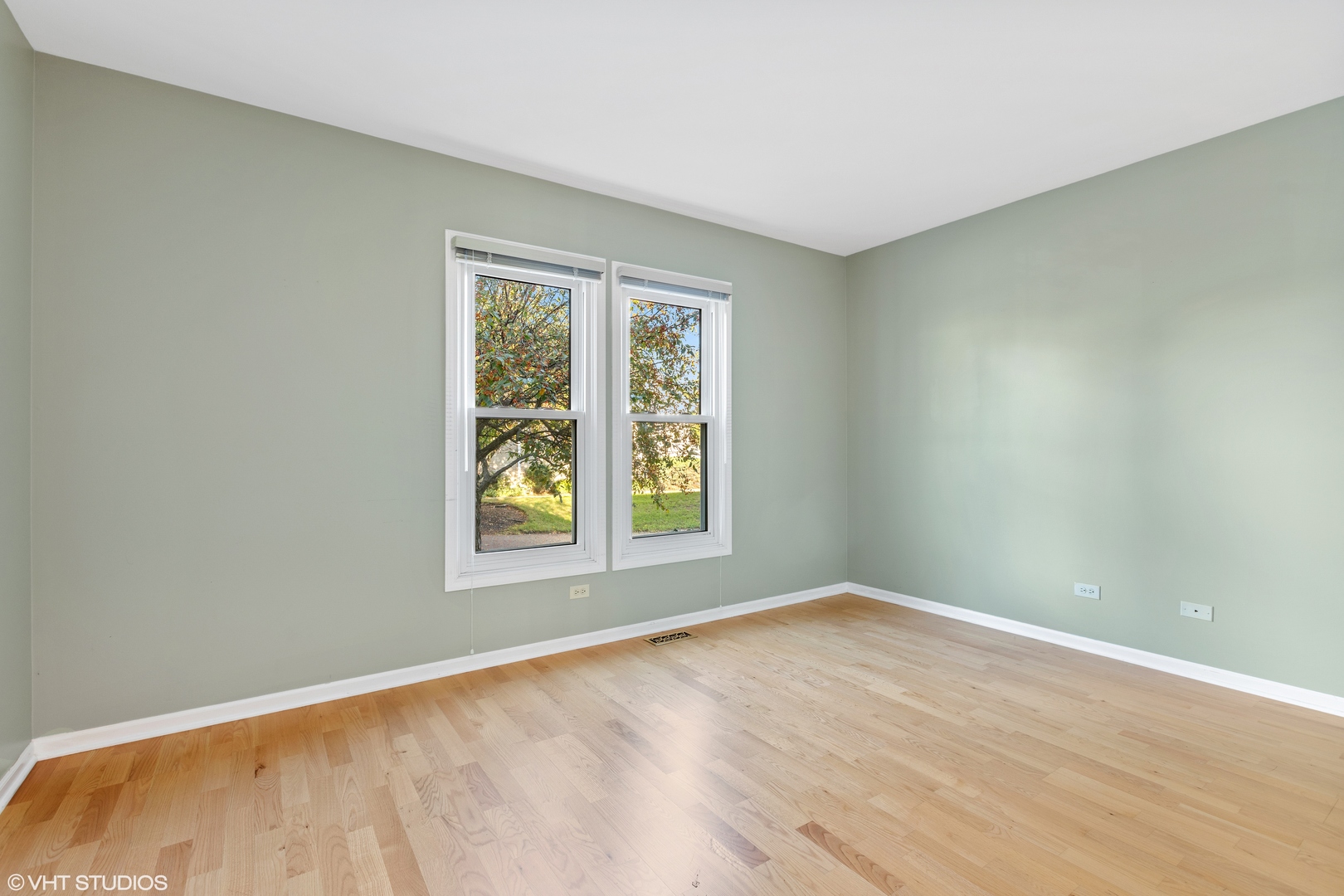 256 Haber Court, Unit 256 Cary, IL 60013 - Photo 10 of 12 a view of an empty room with wooden floor and a window