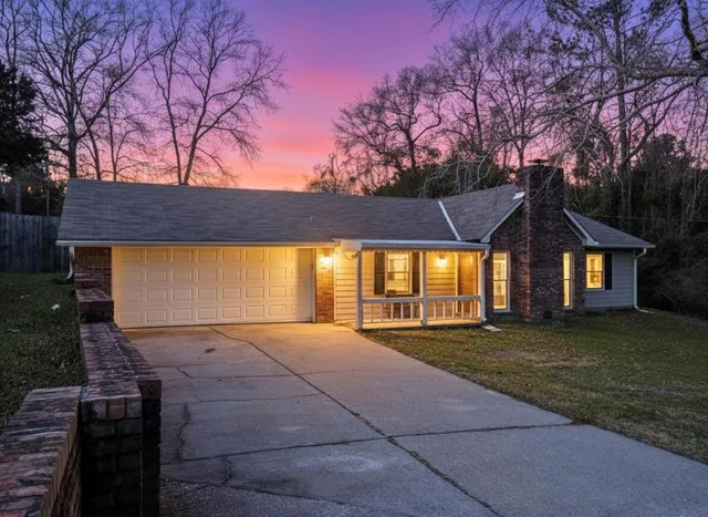 a view of yard with tree in front of it