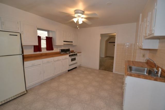 3239 North Leavitt Street, Unit 2 Chicago, IL 60618 - Photo 2 of 12 a kitchen with stainless steel appliances granite countertop a refrigerator a sink a stove and white cabinets