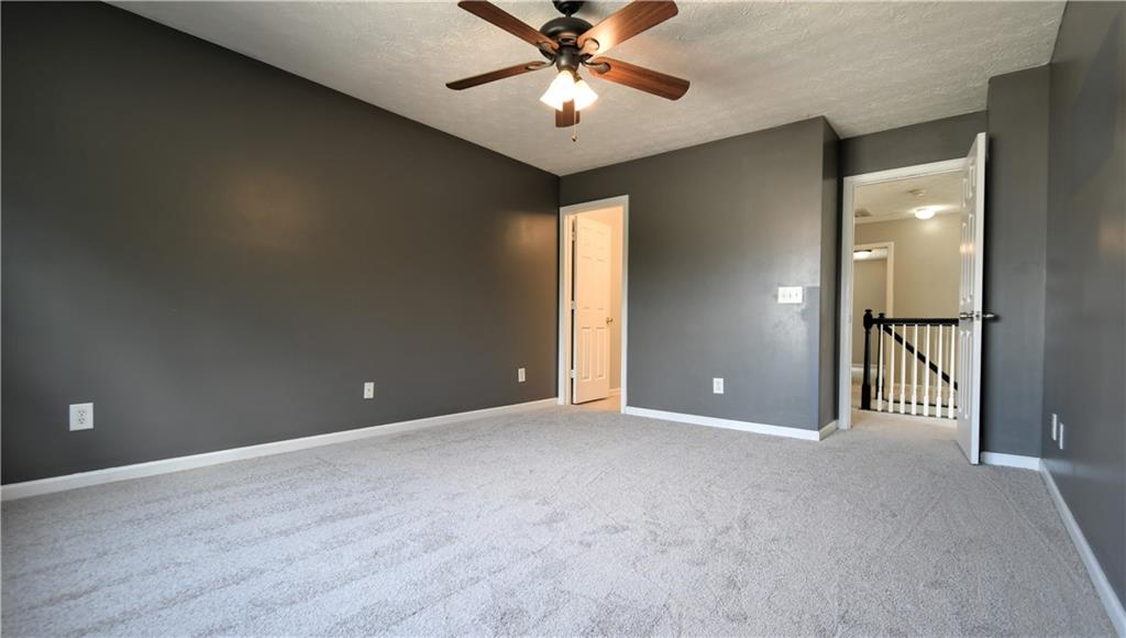 6215 Smoke Ridge Lane Cumming, GA 30041 - Photo 22 of 32 an empty room and chandelier fan