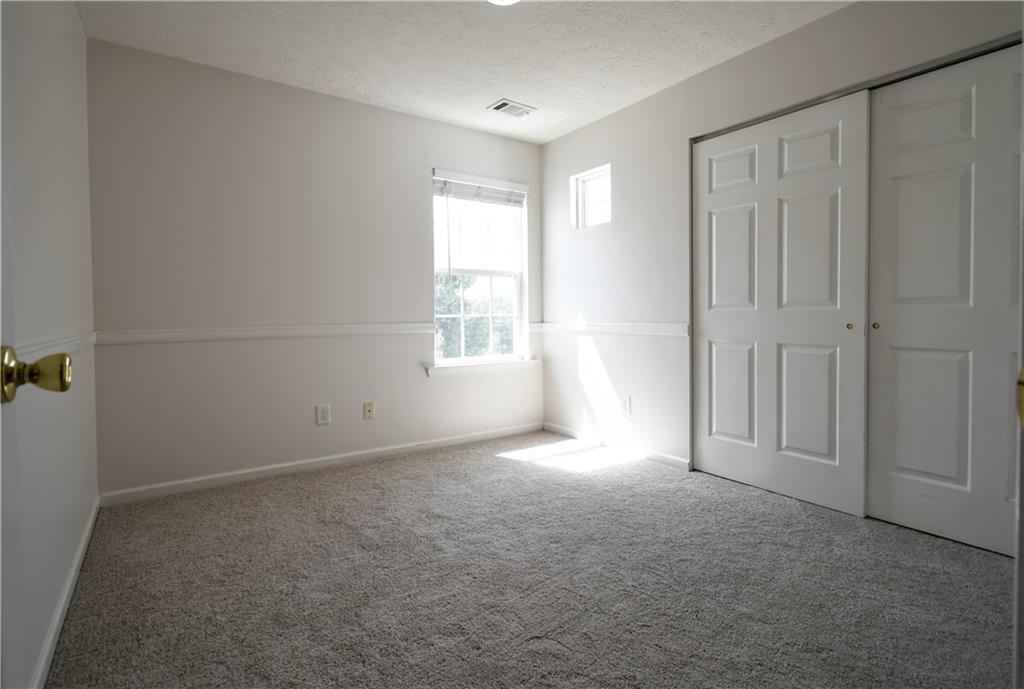 6215 Smoke Ridge Lane Cumming, GA 30041 - Photo 28 of 32 an empty room with windows
