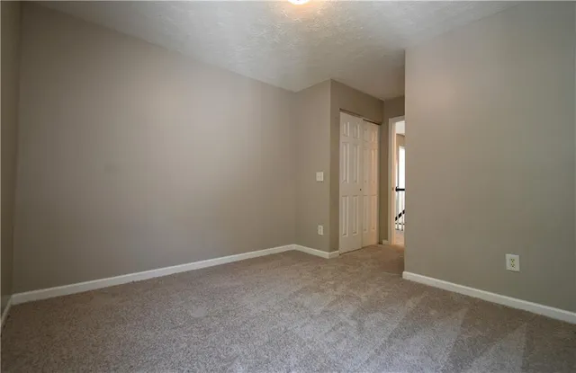 a view of an empty room and closet area