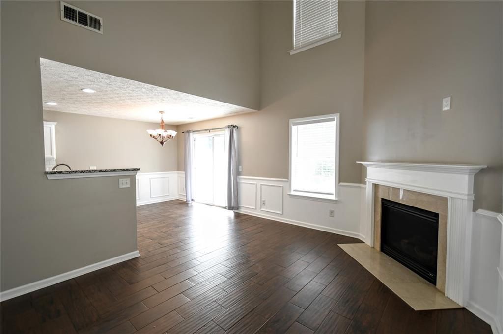 6215 Smoke Ridge Lane Cumming, GA 30041 - Photo 6 of 32 a view of a livingroom with wooden floor and a fireplace
