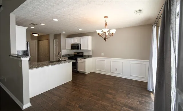 a view of a kitchen with electric appliances