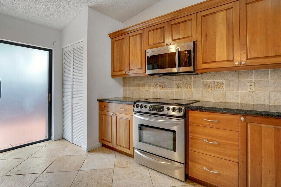 540 Shady Pine Way, Unit B Greenacres, FL 33415 - Photo 7 of 30 Kitchen sliders to patio