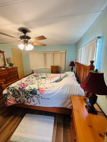 a bedroom with a bed and a chandelier