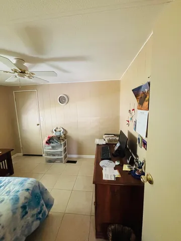 a bedroom with furniture and a mirror