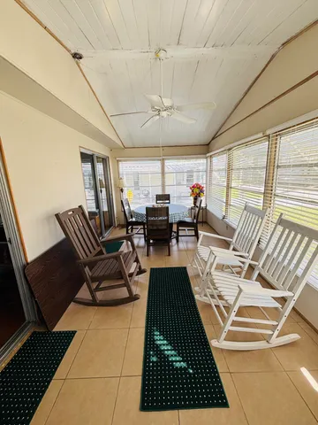 a living room with a rug and a table