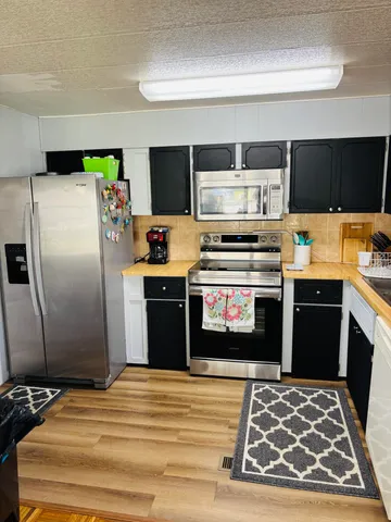 a kitchen with a stove and a refrigerator