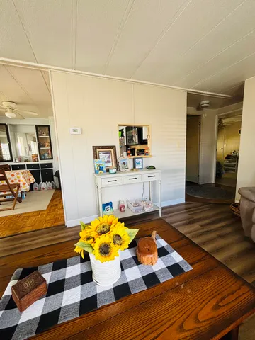 a living room with a gaming machine and dining table