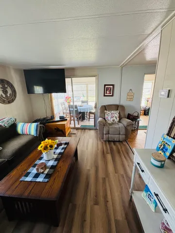 a living room with furniture fireplace and a window