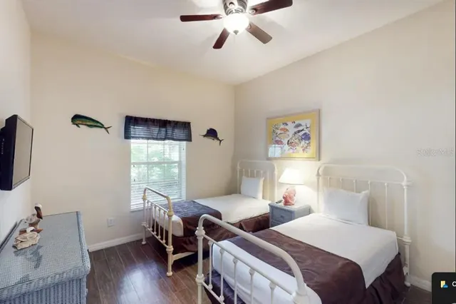 a bedroom with two beds and a window