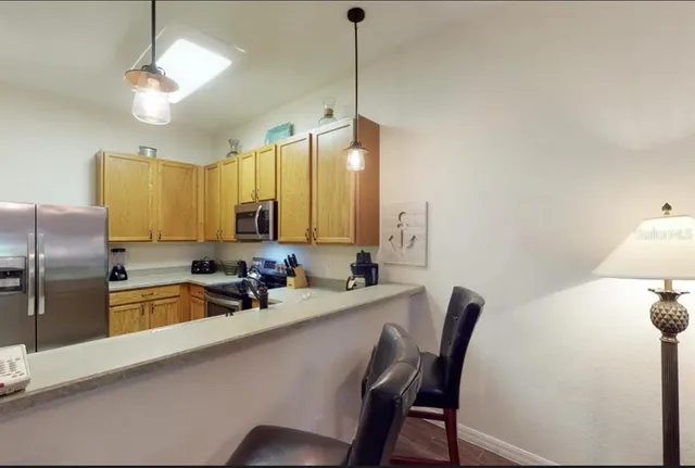 a kitchen with a table chairs sink and cabinets