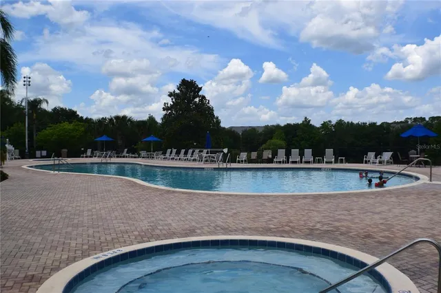 a view of a swimming pool with outdoor seating