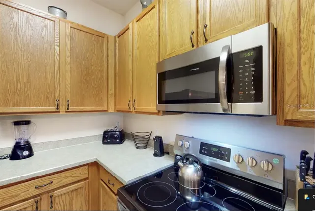 a kitchen with a stove and a microwave