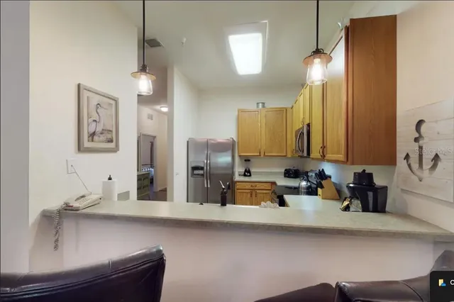 a kitchen with a sink and a refrigerator