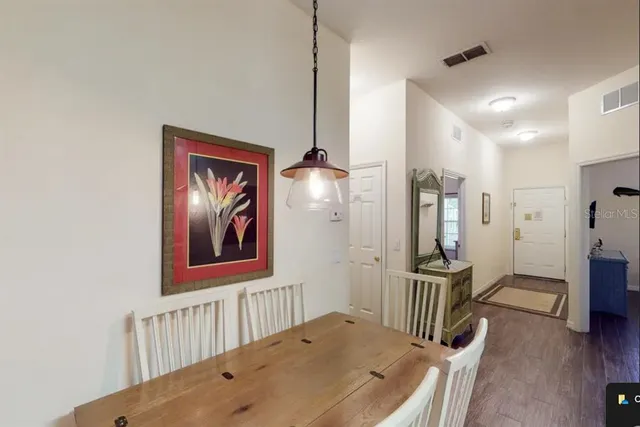 a view of a hallway to a livingroom with furniture