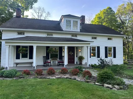front view of a brick house with a yard