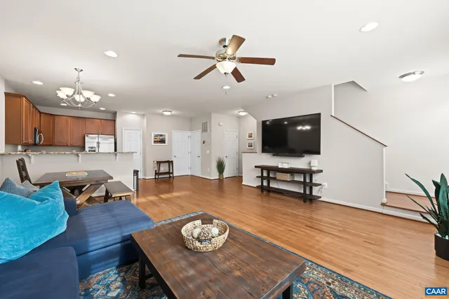 a living room with furniture and kitchen view