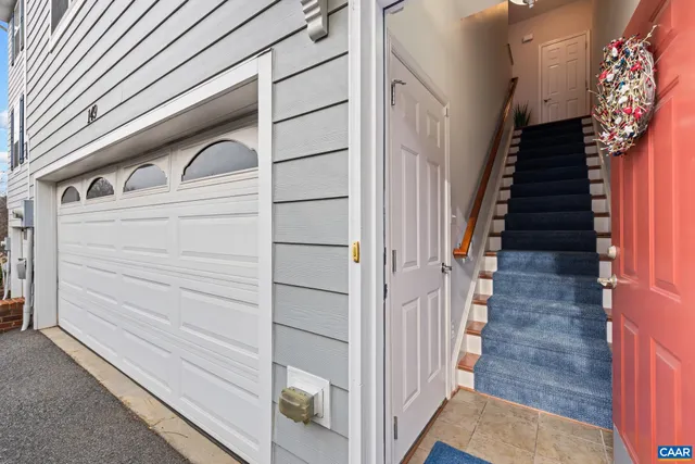 a view of kitchen with stainless steel appliances granite countertop a stove and cabinets