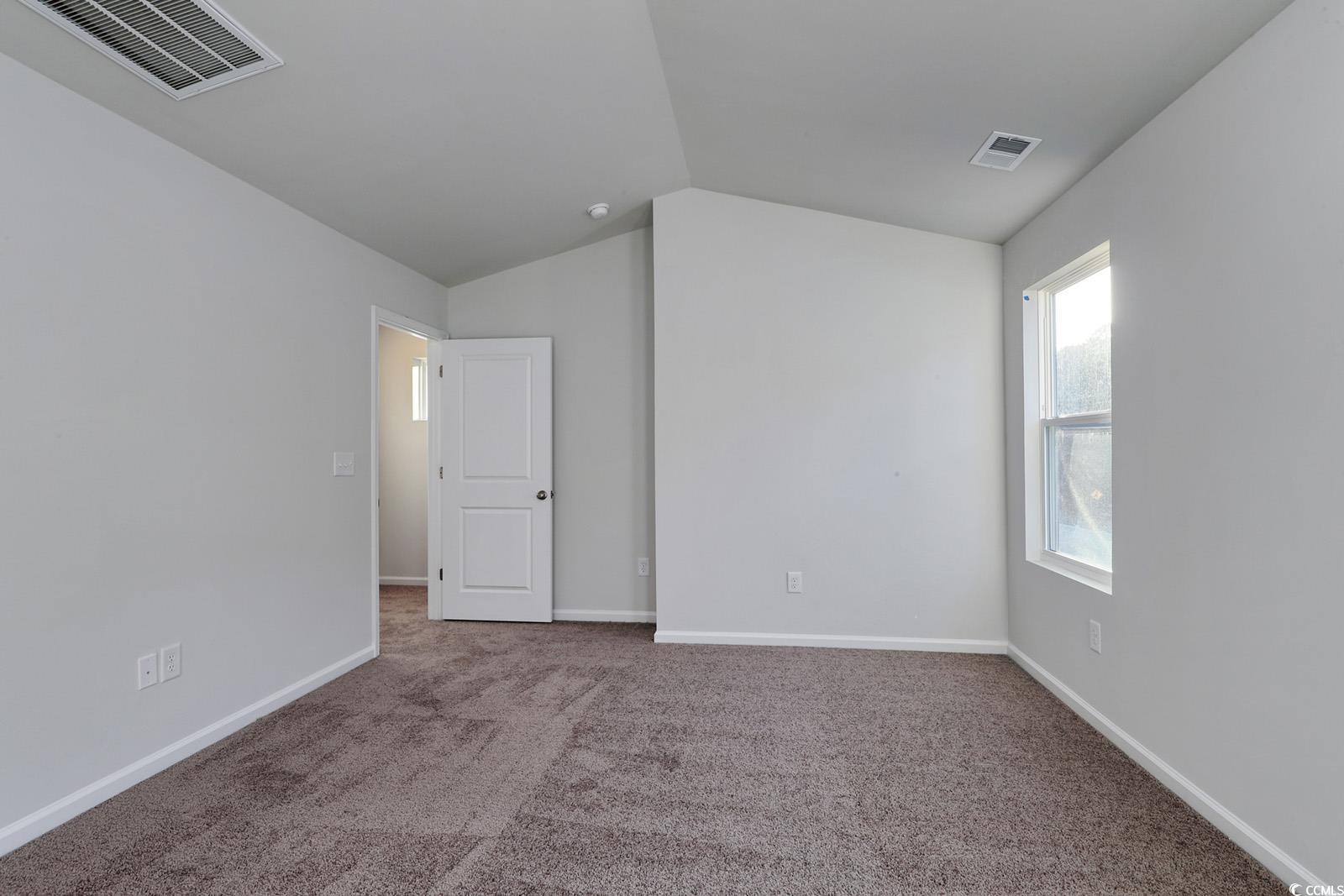 1121 Hainer Place Drive Conway, SC 29526 - Photo 12 of 28 Empty room with lofted ceiling and carpet