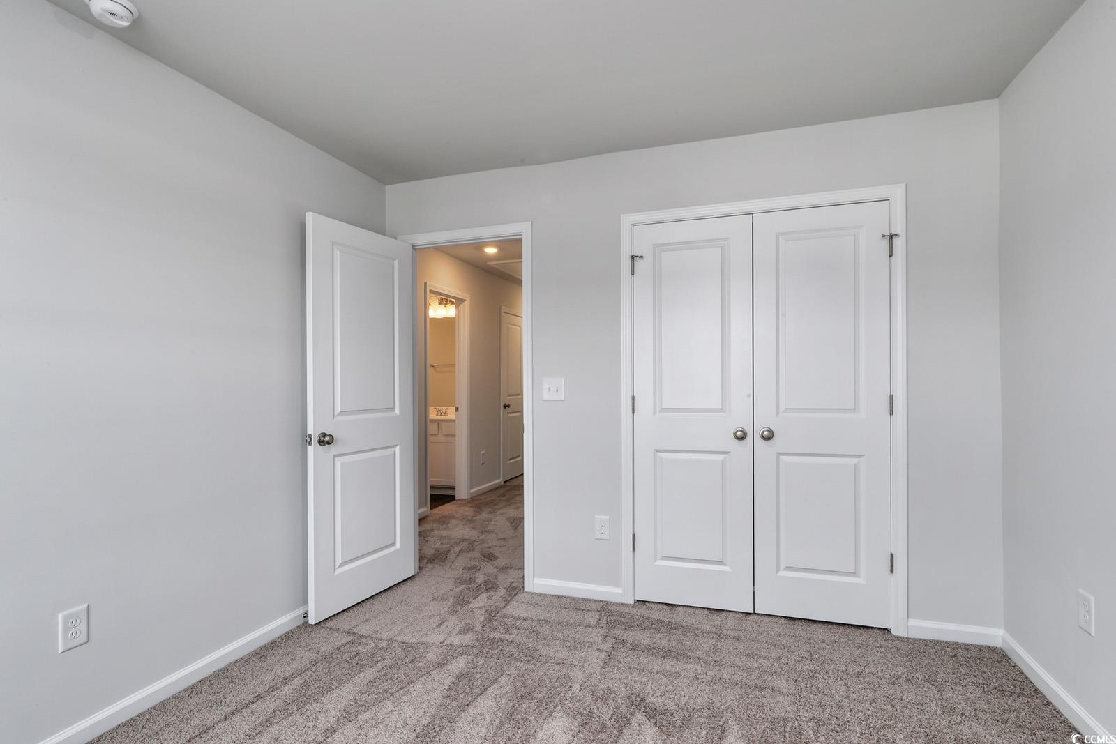 1121 Hainer Place Drive Conway, SC 29526 - Photo 21 of 28 Unfurnished bedroom with light colored carpet and a closet