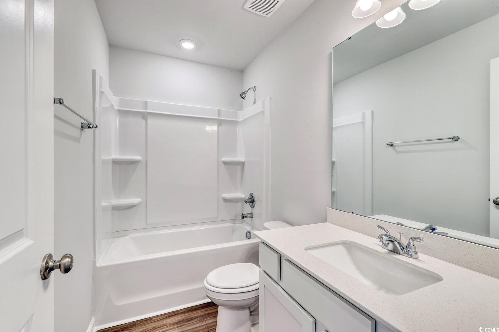 1121 Hainer Place Drive Conway, SC 29526 - Photo 22 of 28 Full bath featuring bathtub / shower combination, vanity, and dark wood-style flooring
