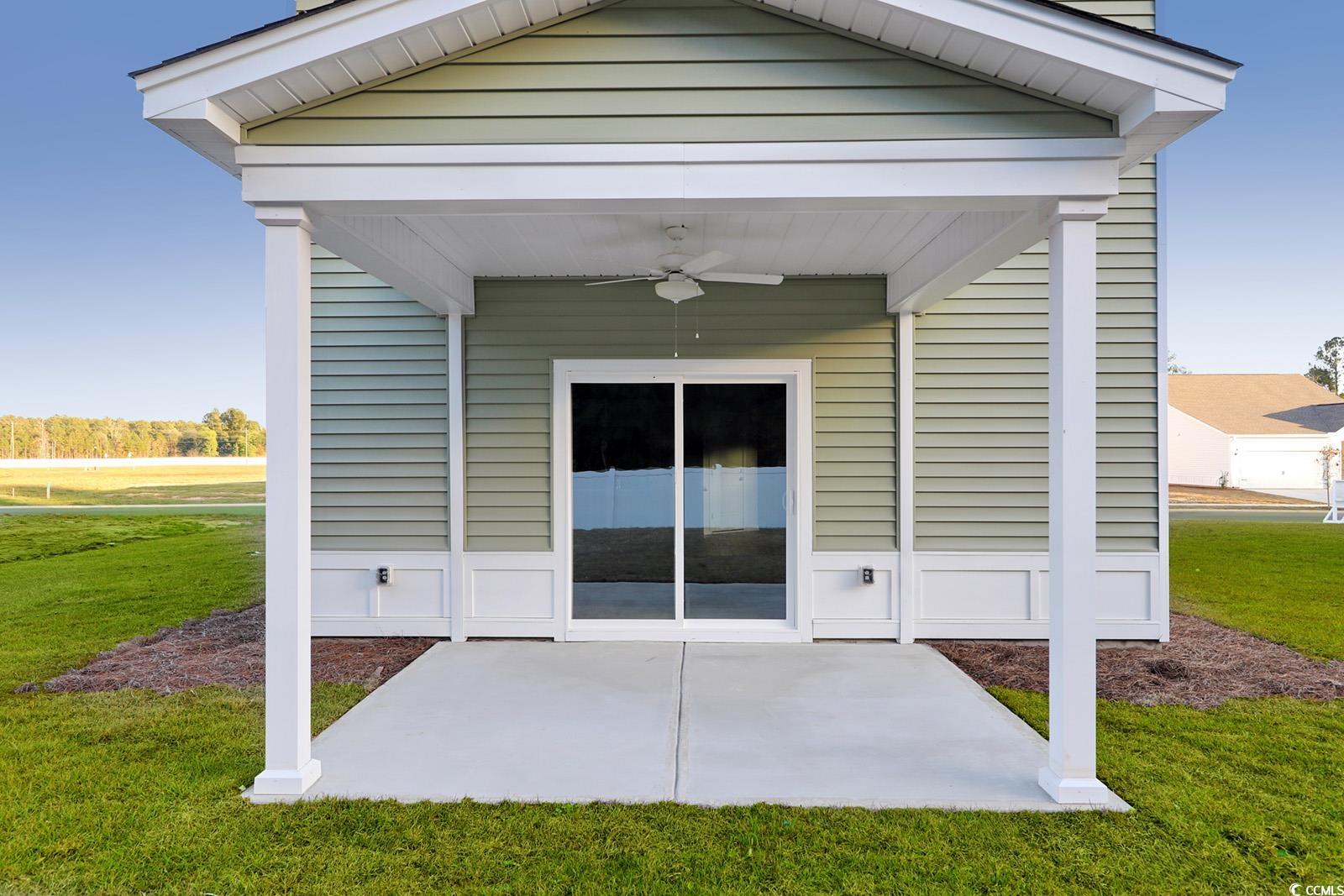 1121 Hainer Place Drive Conway, SC 29526 - Photo 26 of 28 Entrance to property with ceiling fan, a lawn, and a patio