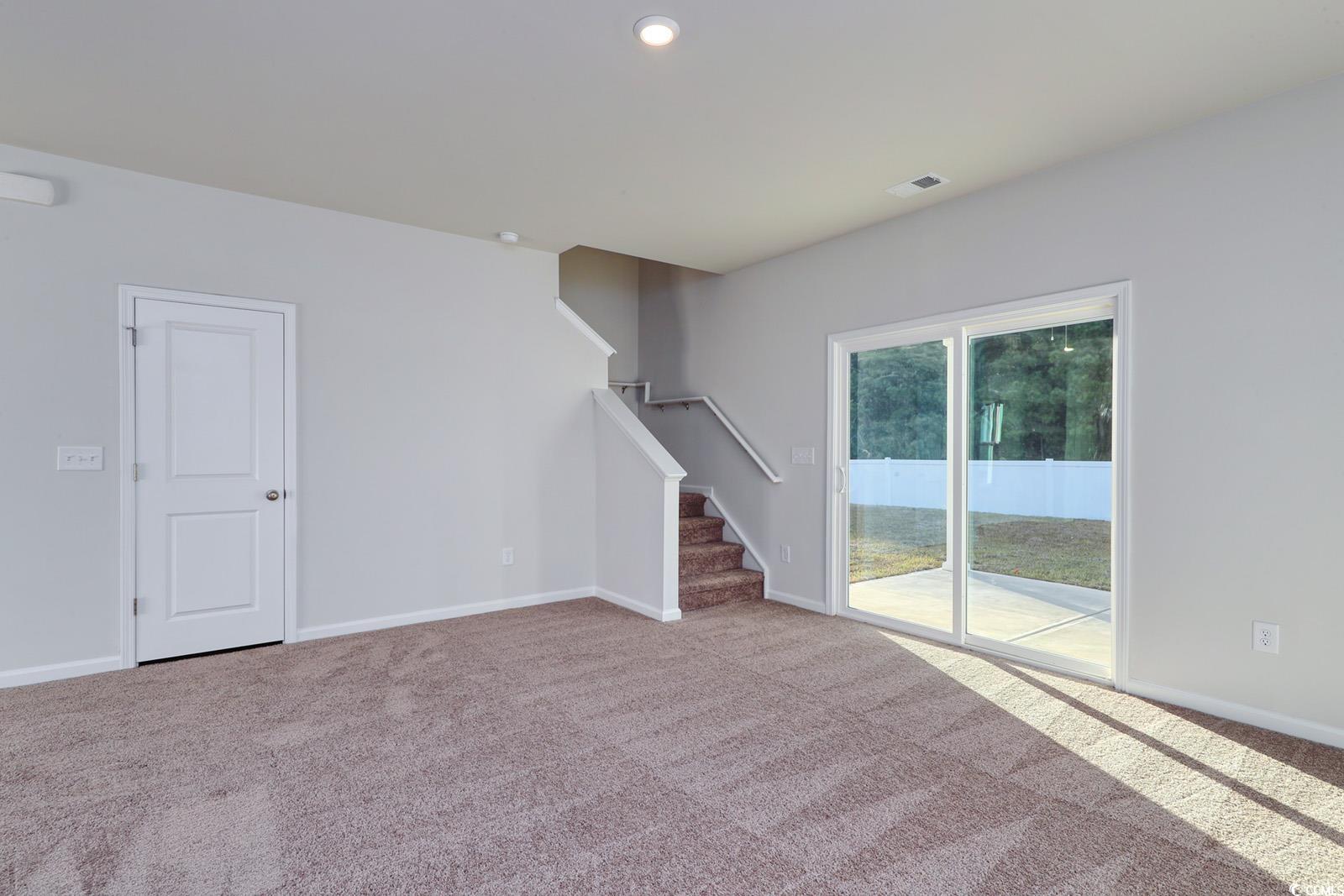 1121 Hainer Place Drive Conway, SC 29526 - Photo 7 of 28 Unfurnished living room featuring stairs and carpet flooring