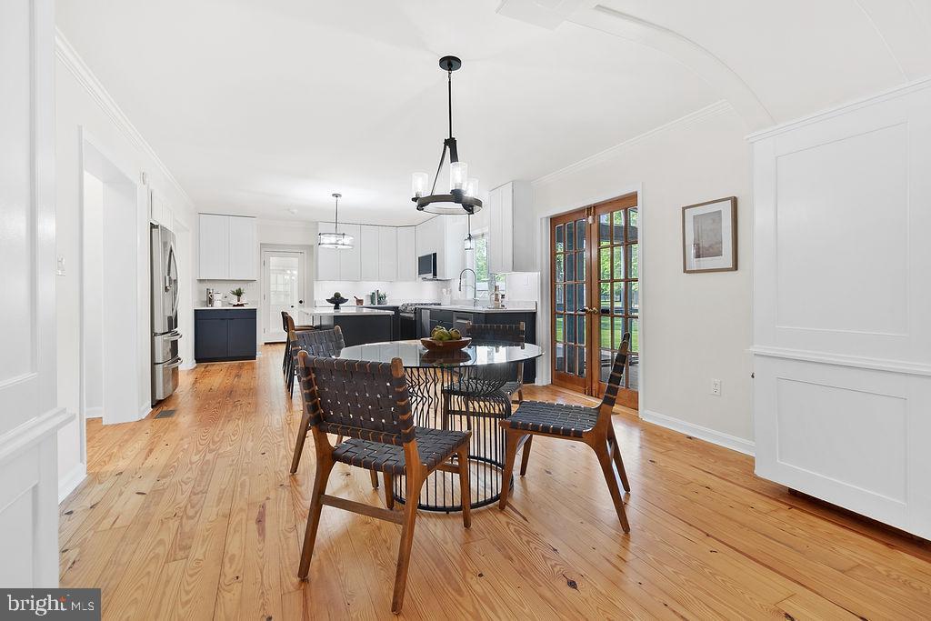 19821 Foggy Bottom Road Bluemont, VA 20135 - Photo 49 of 92 a dining room with furniture a chandelier and wooden floor