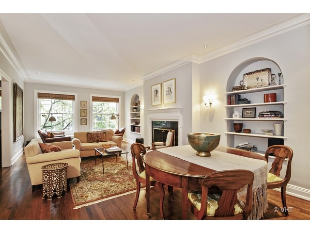 24 East Scott Street, Unit 3 Chicago, IL 60610 - Photo 4 of 10 a dining room with furniture a rug and a fireplace