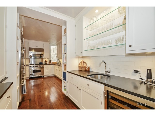 24 East Scott Street, Unit 3 Chicago, IL 60610 - Photo 5 of 10 a kitchen with granite countertop a sink cabinets stainless steel appliances and a counter space