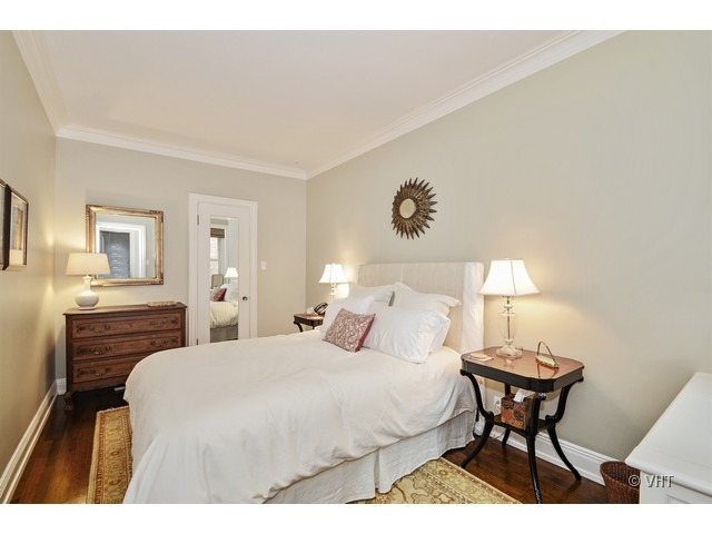 24 East Scott Street, Unit 3 Chicago, IL 60610 - Photo 9 of 10 a bedroom with a bed and wooden floor