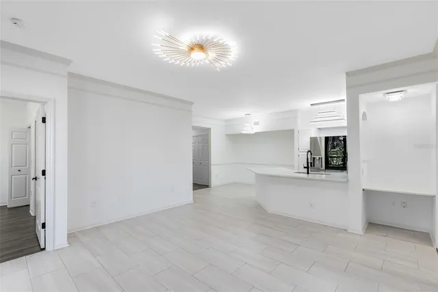 a view of a kitchen with a sink and a refrigerator