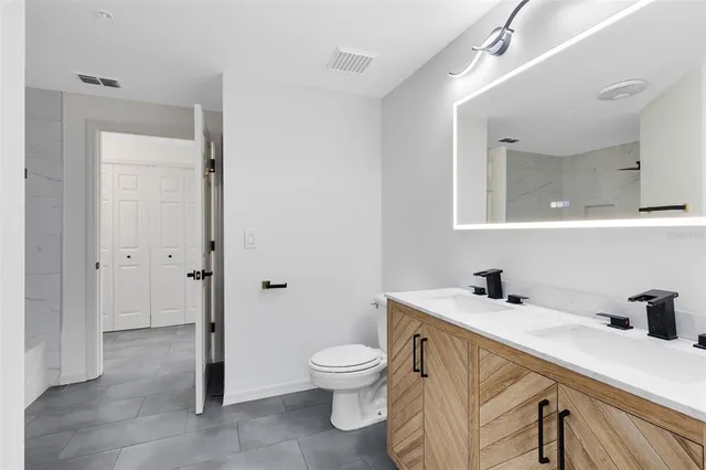 a bathroom with a toilet a sink and a mirror