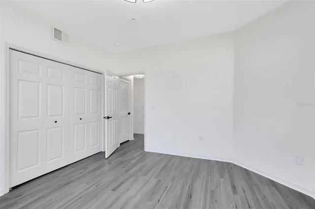 a view of an empty room and wooden floor