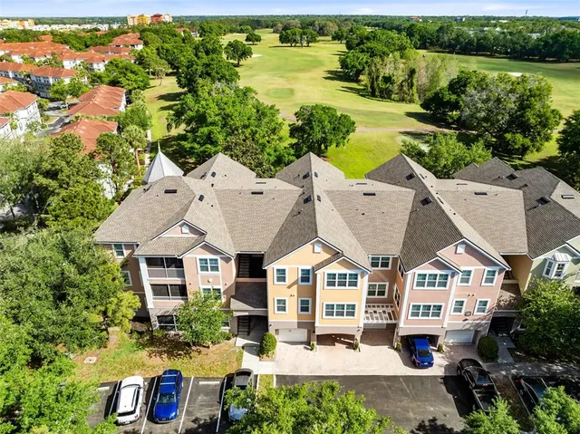an aerial view of a house with a yard