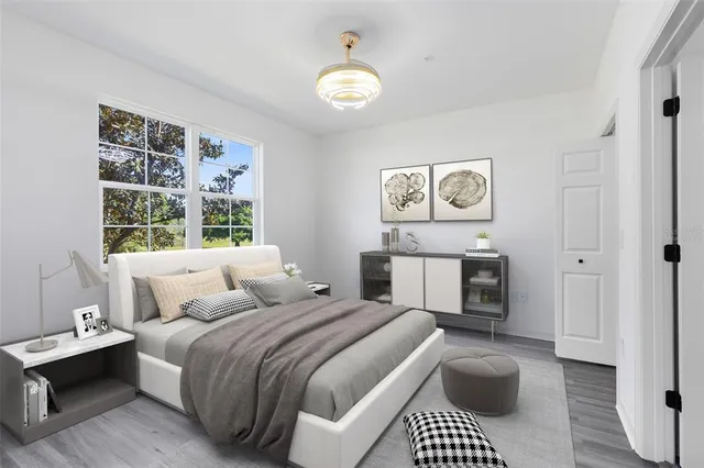 a bedroom with a bed and a chandelier