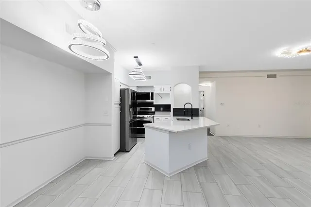 a kitchen with cabinets and wooden floor