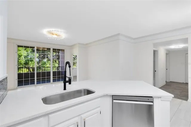 a kitchen with a sink and large window