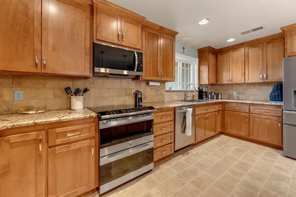a kitchen with a stove top oven sink and cabinets