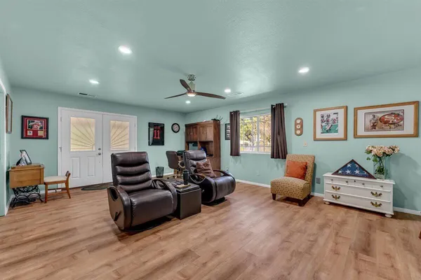 a living room with furniture and wooden floor